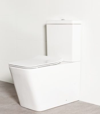 Milu Odourless Form back-to-wall toilet has a modern rectangular design, it is photographed against a white tiled bathroom wall