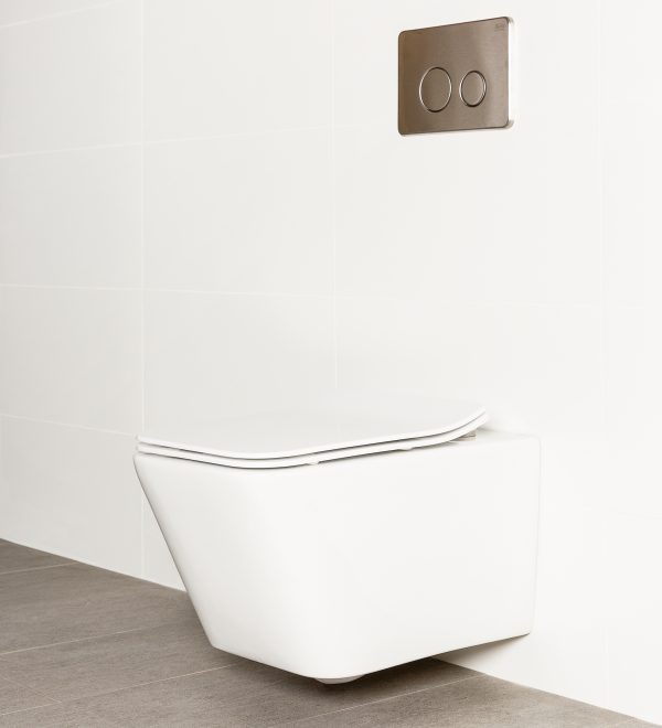 Milu Form in-wall wall mounted odourless toilet, has a rectangular shaped pan with a strong minimal design. The toilet is mounted on a white tiled wall