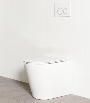 Milu Odourless Mod in-wall floor mounted toilet shown with a white flush plate. Pan design design has a straight profile, the cistern is hidden behind the wall